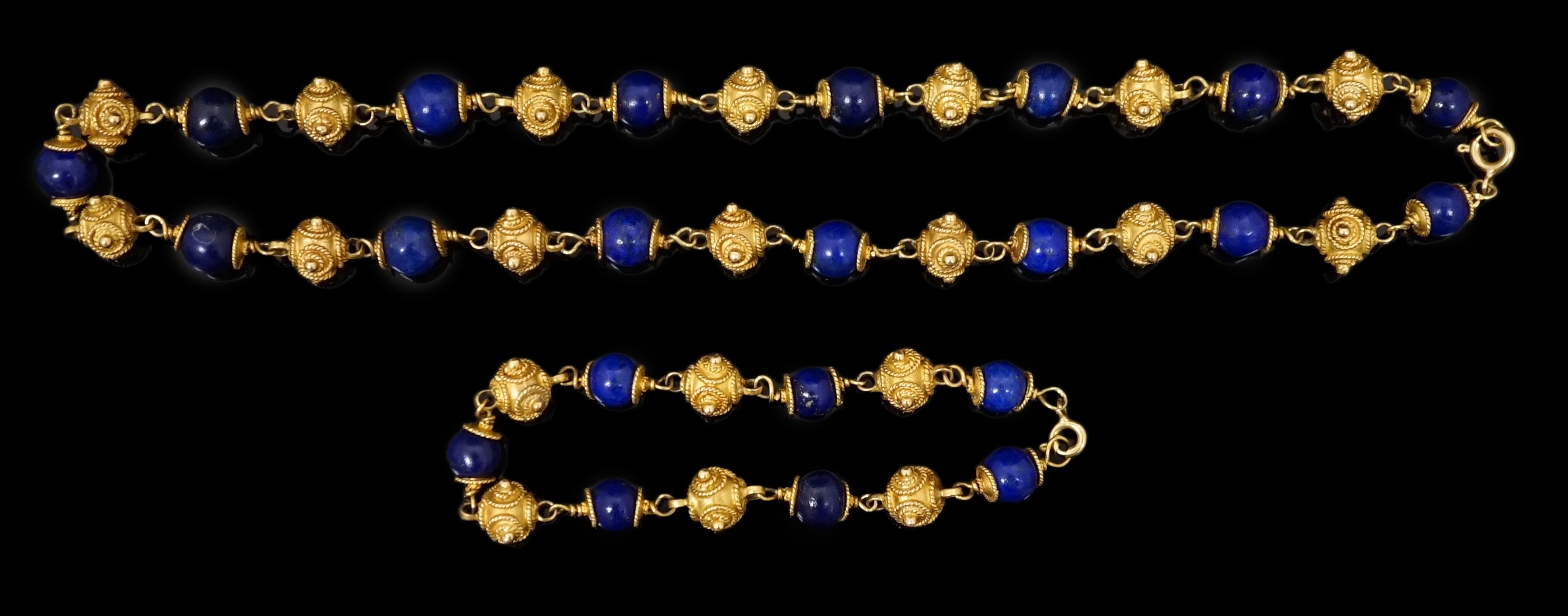 A 20th century Middle Eastern high carat gold canetile work bead and lapis lazuli bead set necklace and matching bracelet